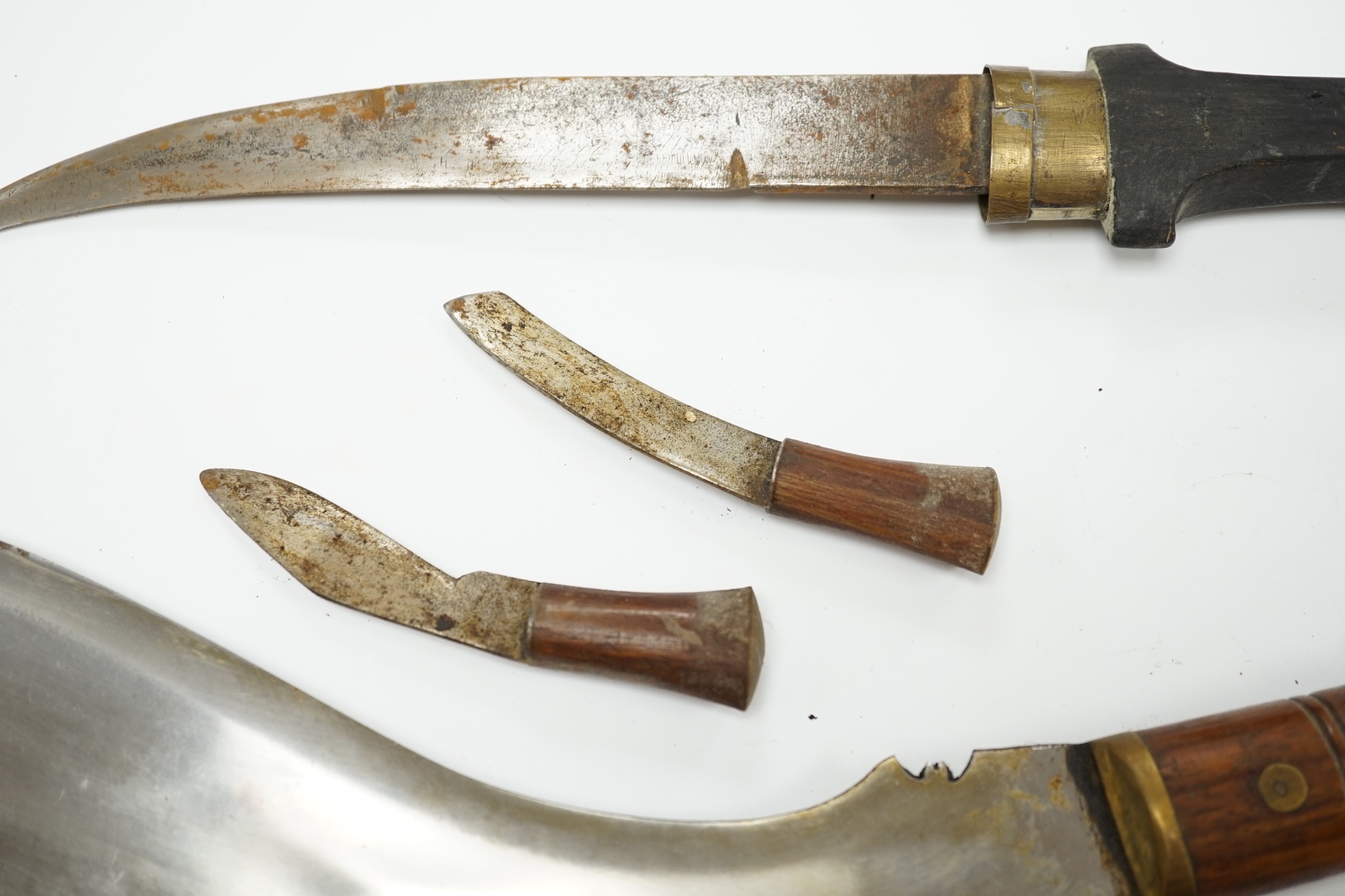 An Indian Kukri with brass mounted wooden handle its leather sheath, and a Moroccan Jambiya. Condition - good